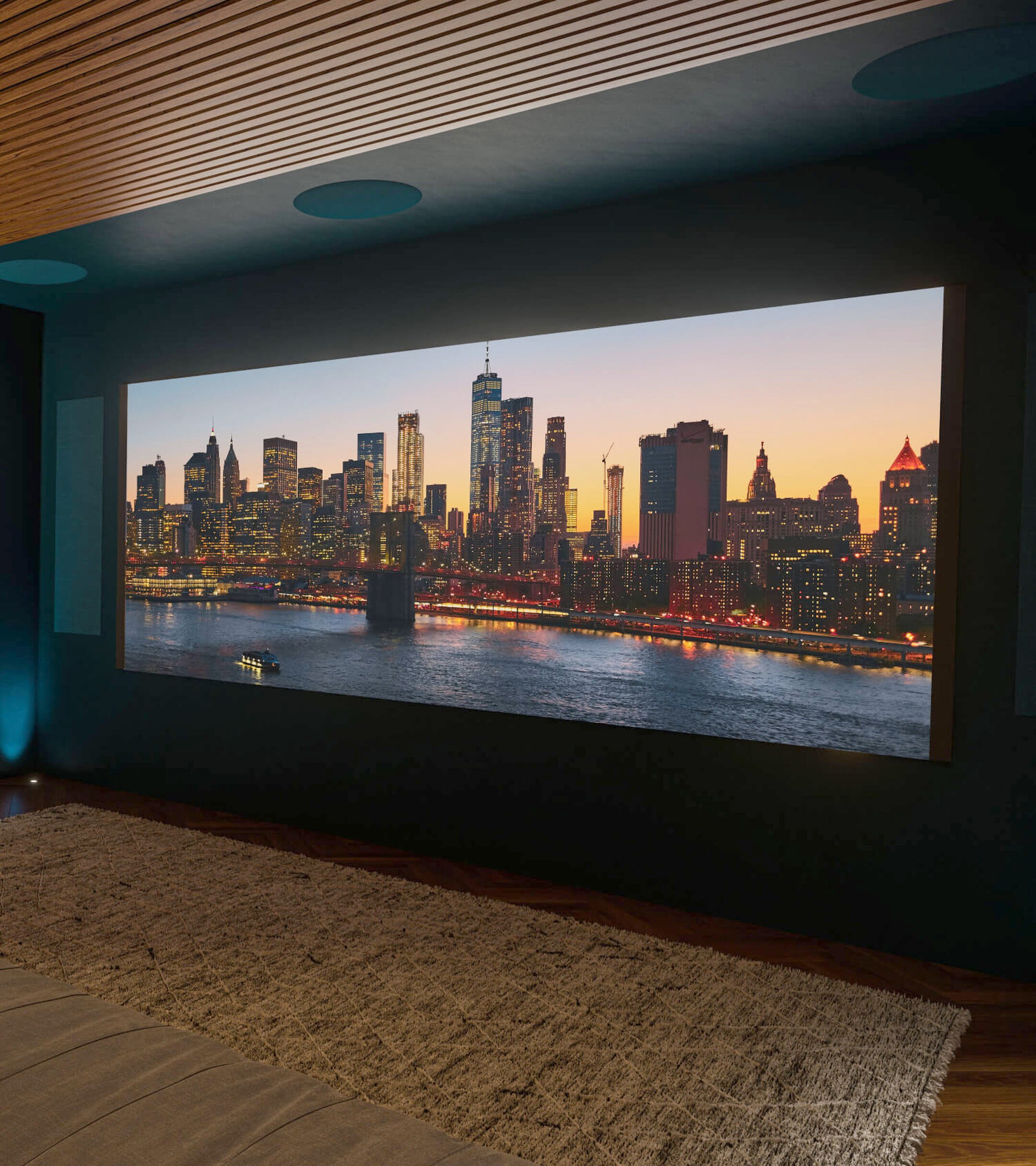 Private cinema room with acoustic wood-slat walls and a full-width projection screen