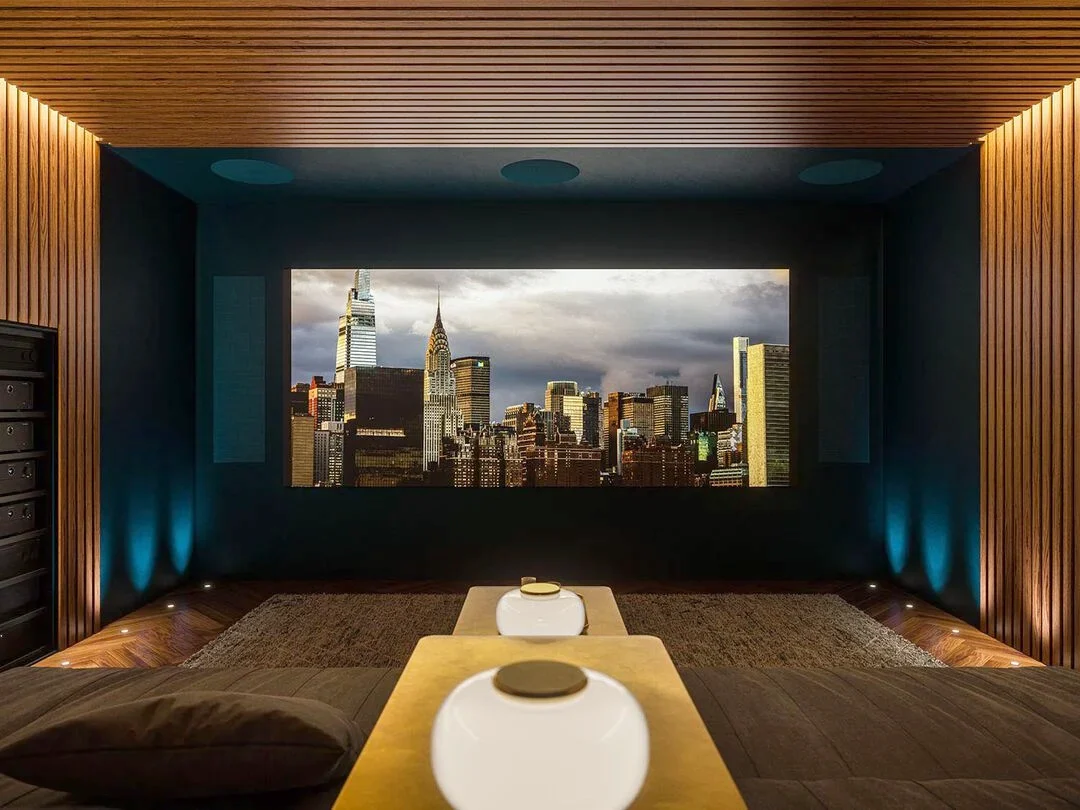 Private cinema room with acoustic wood panels and a widescreen projection screen