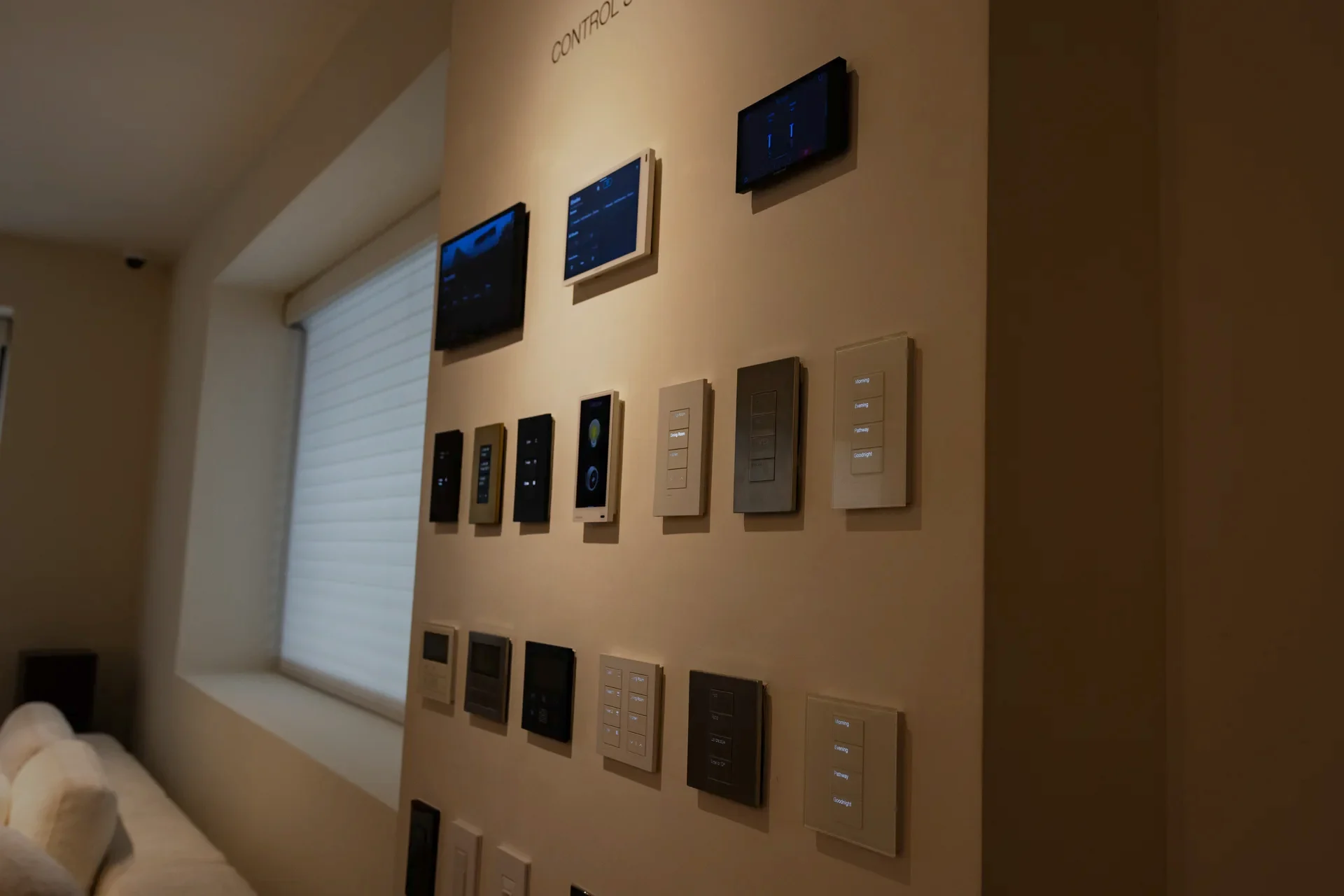 Crestron and Lutron control surfaces on a wall in the Stereotek showroom